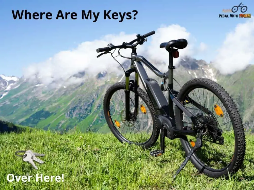 Electric Bike on a hillside with keys on the grass